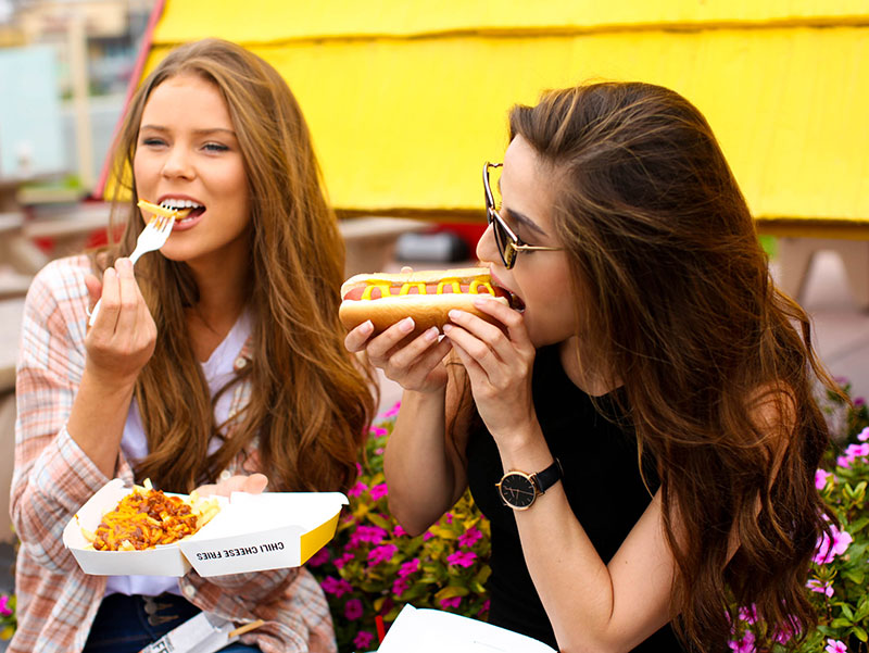 Wienerschnitzel Customers enjoying Hot Dogs